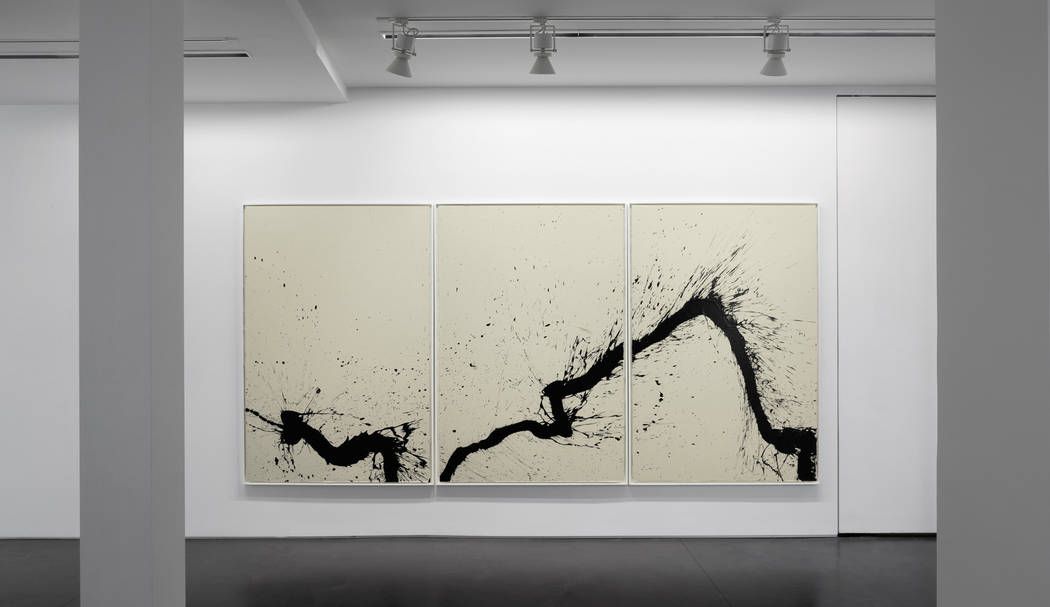 Minimalist black ink abstract triptych artwork displayed in a clean white gallery space, showcasing expressive modern design with the same elegance offered by Facial services Tysons Corner.
