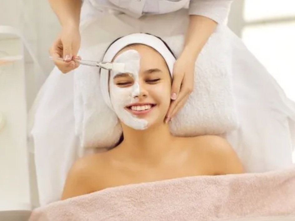 “A person enjoying a relaxing facial treatment with a soothing cream mask being applied, representing professional facial services in Tysons Corner.”